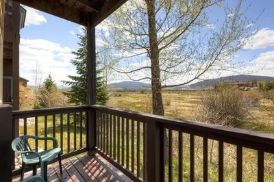 a deck with a chair and a view of the mountains at Tarn Landing C-5 Condo in Frisco