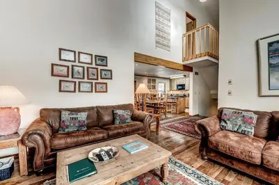 a living room with leather couches and a coffee table at Mountainside 673 Home in Frisco