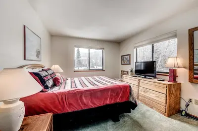 a bedroom with a bed and a flat screen tv at Mountainside 673 Home in Frisco