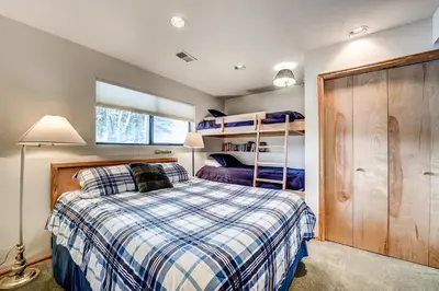 a bedroom with a bed and bunk beds at Mountainside 673 Home in Frisco