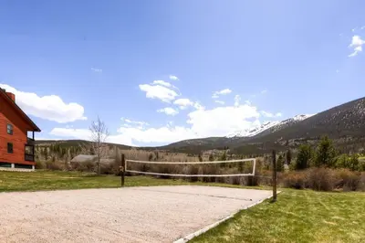 a volleyball court in a field next to a house at Mountainside 673 Home in Frisco