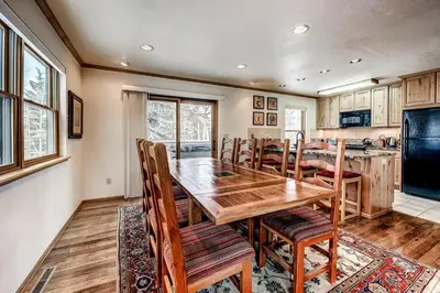 a kitchen and dining room with a wooden table and chairs at Mountainside 673 Home in Frisco