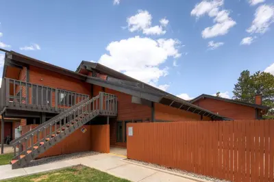 a house with a wooden fence in front of it at Mountainside 229E Condo in Frisco