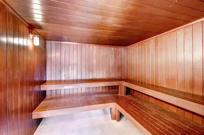a empty sauna with wooden walls and wooden benches at Mountainside 229E Condo in Frisco