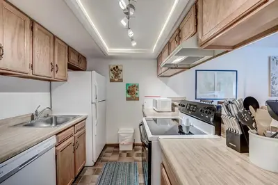 a kitchen with a sink and a stove top oven at Mountainside 229E Condo in Frisco