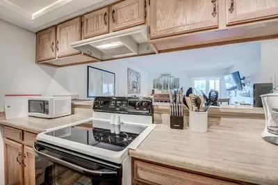 a kitchen with wooden cabinets and a stove top oven at Mountainside 229E Condo in Frisco