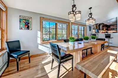 a kitchen and dining room with a wooden table and chairs at Frisco Street Home in Frisco