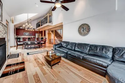 a living room with a leather couch and a table at Frisco River Townhomes #D in Frisco