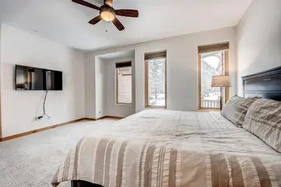 a bedroom with a bed and a ceiling fan at Frisco River Townhomes #D in Frisco