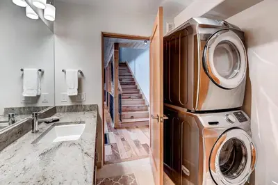 a bathroom with a washing machine and a sink at Frisco River Townhomes #D in Frisco