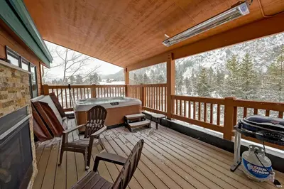 a screened in porch with chairs and a hot tub at Frisco River Townhomes #D in Frisco