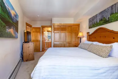 a bedroom with a large bed and a television at 2640 Tenderfoot Lodge Condo in Keystone