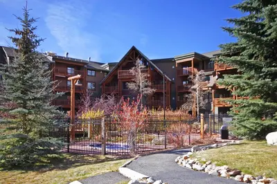 a large building with a fence in front of it at 2640 Tenderfoot Lodge Condo in Keystone