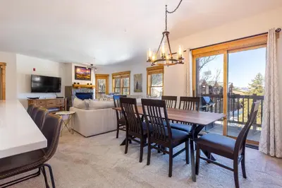 a dining room and living room with a table and chairs at 2640 Tenderfoot Lodge Condo in Keystone