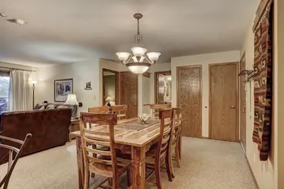 a dining room with a wooden table and chairs at 204 Snowdance Manor Condo in Keystone