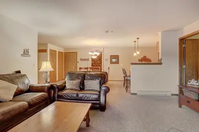 a living room with leather furniture and a white screen at 204 Snowdance Manor Condo in Keystone