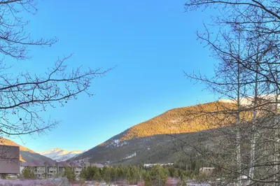 a mountain in the distance with trees and buildings at 204 Snowdance Manor Condo in Keystone