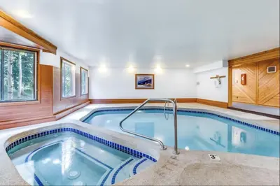 a pool in a house with a hot tub at 204 Snowdance Manor Condo in Keystone