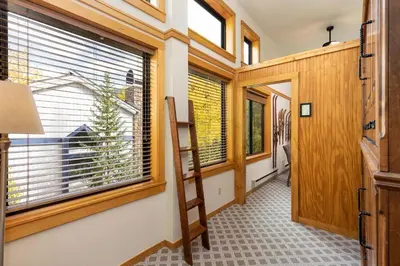 a hallway with windows and a staircase in a house at Penthouse 2796 Slopeside Ski In Ski Out Condo in Keystone