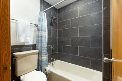 a bathroom with a toilet and a bath tub at Penthouse 2796 Slopeside Ski In Ski Out Condo in Keystone