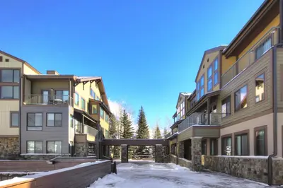 a row of apartment buildings in the snow at Penthouse 2796 Slopeside Ski In Ski Out Condo in Keystone