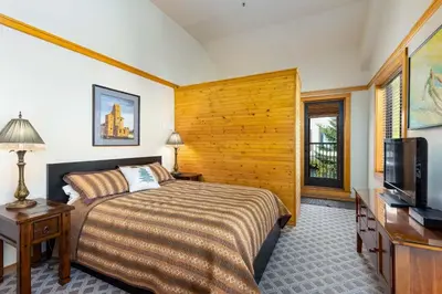 a bedroom with a bed and a flat screen tv at Penthouse 2796 Slopeside Ski In Ski Out Condo in Keystone