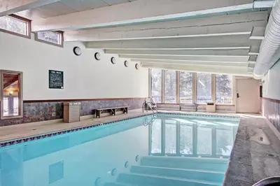 a swimming pool in a building with windows at 2964 Key Condo in Keystone