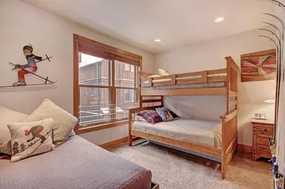 a bedroom with two bunk beds and a window at River Run Mill Creek Combo Condo in Keystone