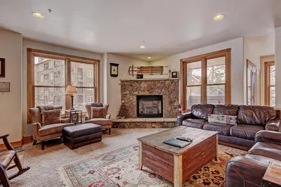 a living room with a couch and a fireplace at River Run Mill Creek Combo Condo in Keystone