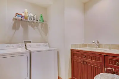 a kitchen with a washing machine and a sink at River Run Mill Creek Combo Condo in Keystone