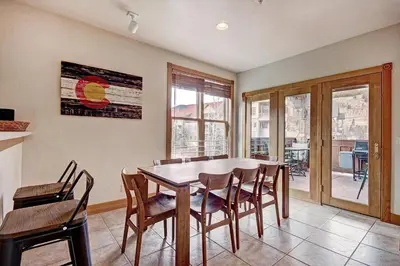 a dining room with a table and chairs at River Run Mill Creek Combo Condo in Keystone