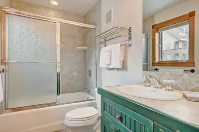 a bathroom with a sink and a toilet and a shower at River Run Mill Creek Combo Condo in Keystone