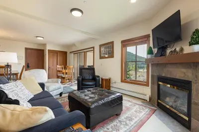 a living room with a couch and a fireplace at 201 Oro Grande Condo in Keystone