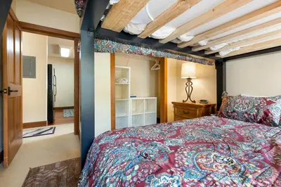 a bedroom with a bed with a red bedspread at 201 Oro Grande Condo in Keystone