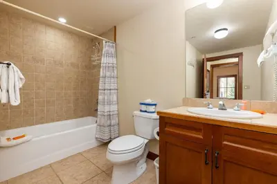 a bathroom with a toilet and a sink and a tub at 201 Oro Grande Condo in Keystone