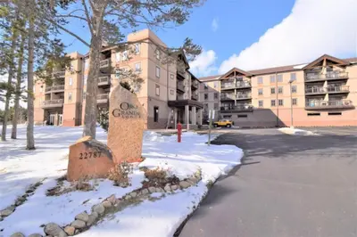 a sign in the snow in front of a building at 201 Oro Grande Condo in Keystone