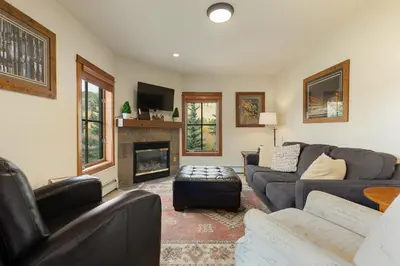 a living room with a couch and a fireplace at 201 Oro Grande Condo in Keystone