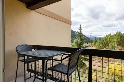 a table and chairs on a balcony with a view at 201 Oro Grande Condo in Keystone