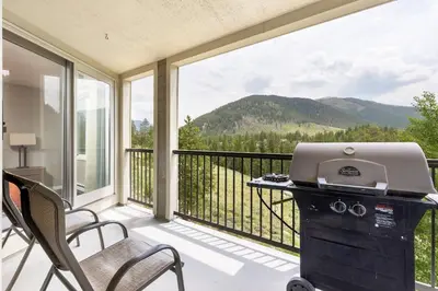 a balcony with a desk and a laptop on it at 2112 The Pines Condo in Keystone