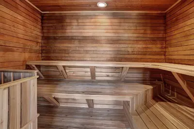 an empty sauna with wooden walls and wooden floors at 2112 The Pines Condo in Keystone