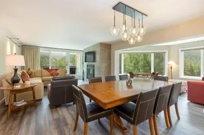 a dining room and living room with a table and chairs at 2112 The Pines Condo in Keystone