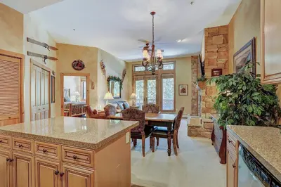 a kitchen and living room with a table and a dining room at 3056 The Timbers Condo in Keystone