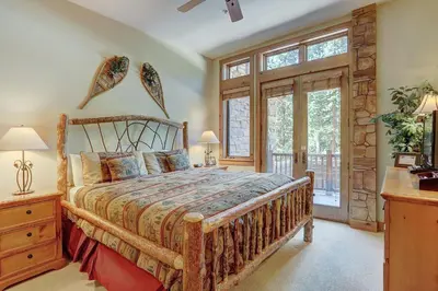 a bedroom with a wooden bed and a window at 3056 The Timbers Condo in Keystone