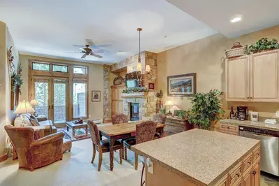 a kitchen and dining room with a table and chairs at 3056 The Timbers Condo in Keystone
