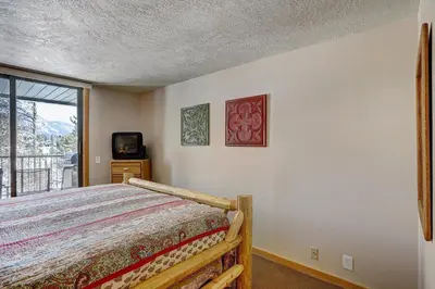 a bedroom with a bed and a window at 2065 The Pines Condo in Keystone
