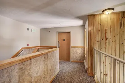 a hallway with a gym with wooden walls at 2065 The Pines Condo in Keystone
