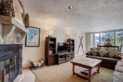 a living room with a couch and a fireplace at 2065 The Pines Condo in Keystone