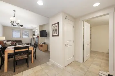 a living room and dining room with a dining table at 4368 Founders Pointe Cozy WP Village Condo in Winter Park