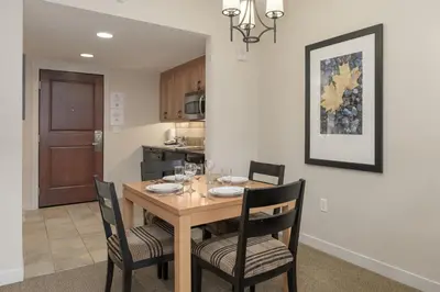 a dining room with a wooden table and chairs at 4368 Founders Pointe Cozy WP Village Condo in Winter Park