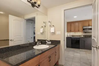 a large bathroom with a sink and a kitchen at 4368 Founders Pointe Cozy WP Village Condo in Winter Park
